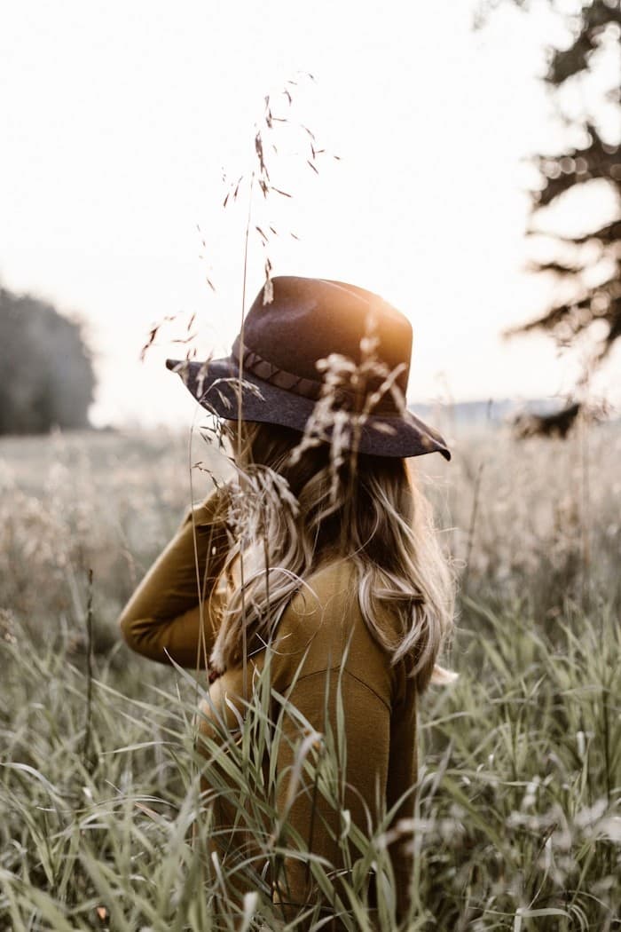 A woman standing in golden, wind-touched grasses